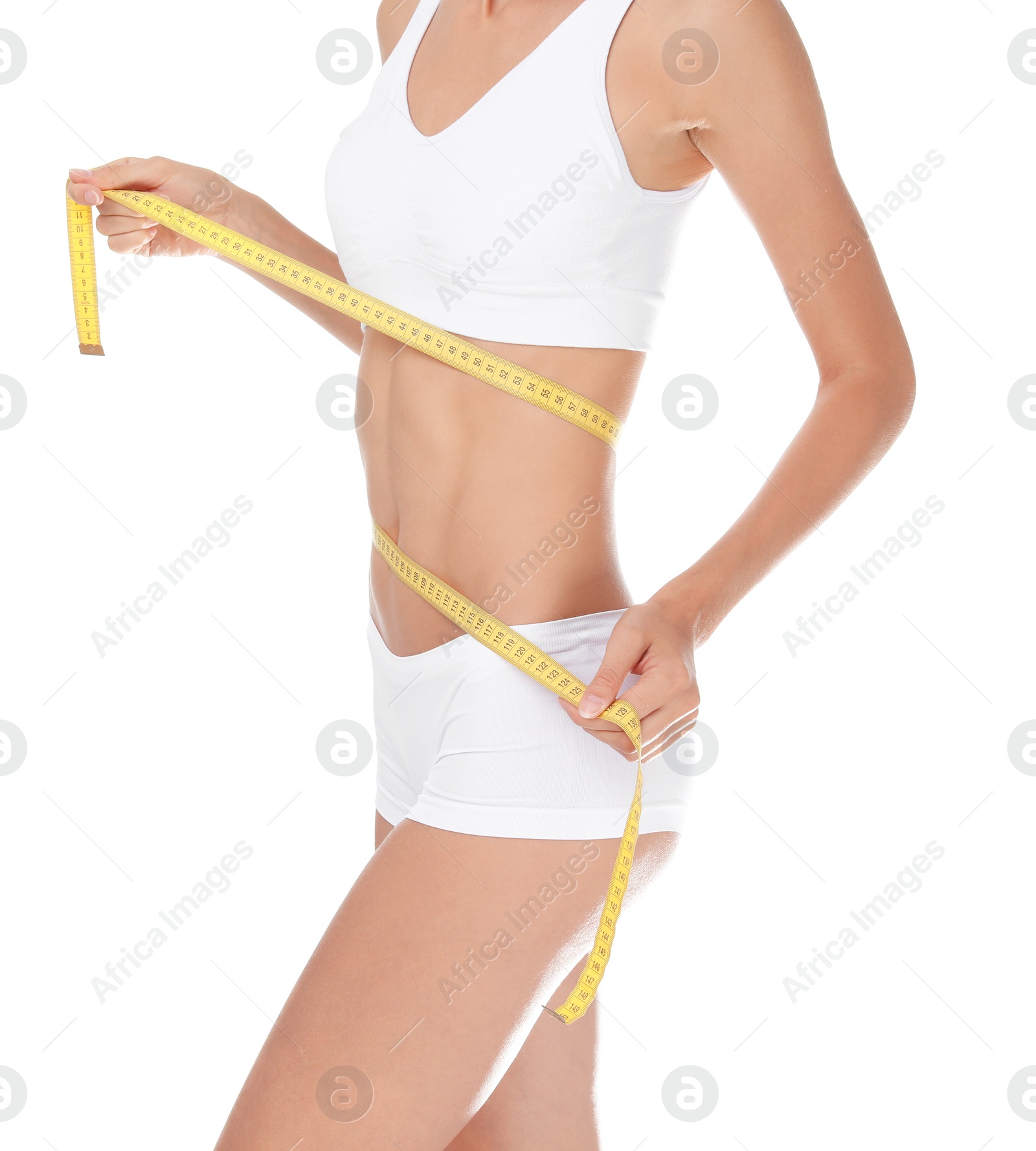 Photo of Young slim woman in underwear with measuring tape on white background. Weight loss diet