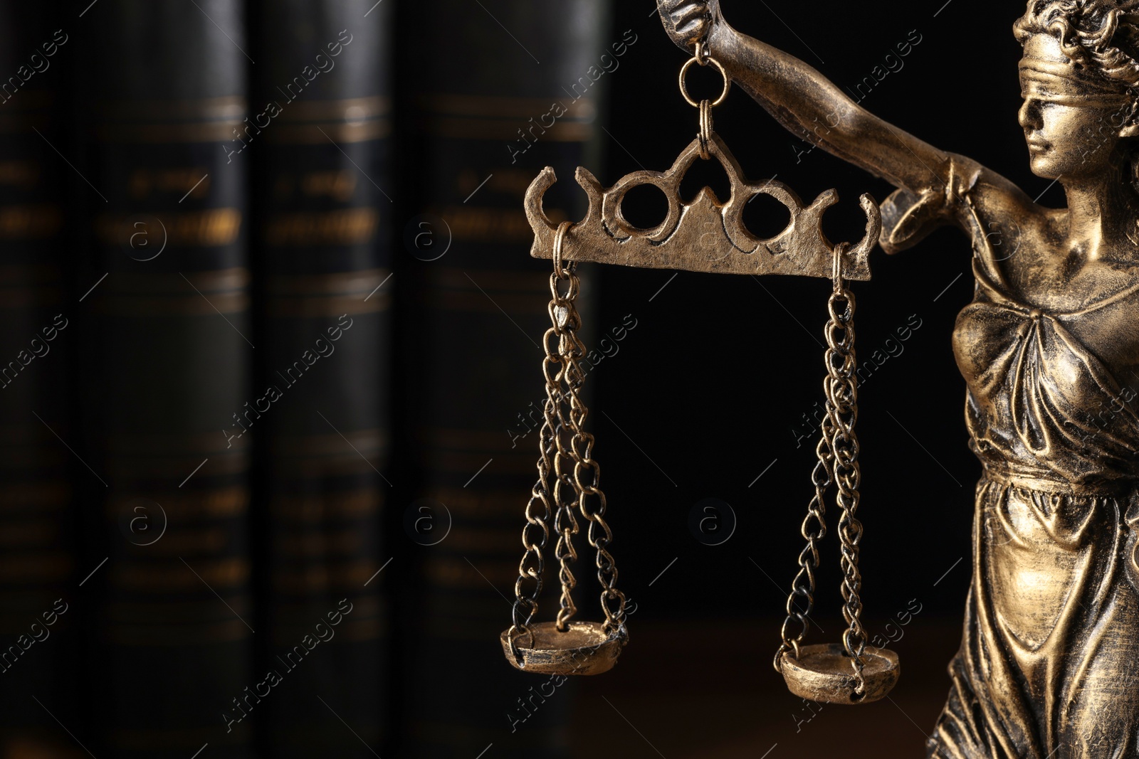 Photo of Symbol of fair treatment under law. Statue of Lady Justice on dark background, closeup. Space for text