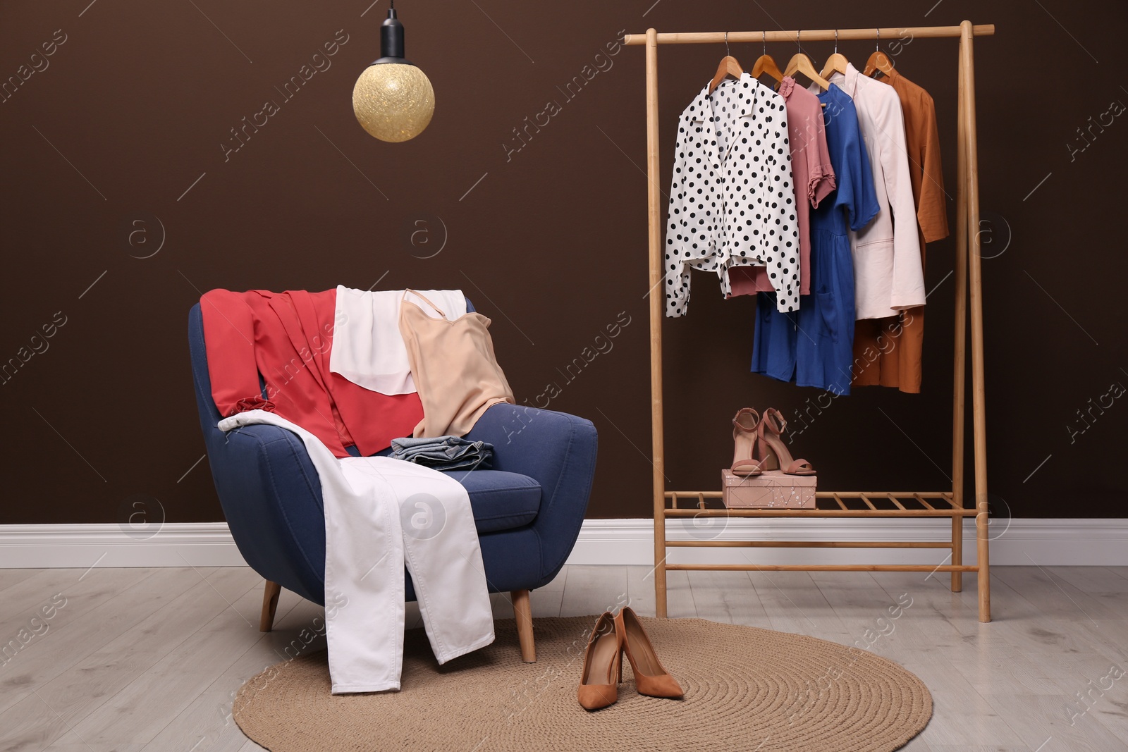 Photo of Different clothes and shoes in dressing room