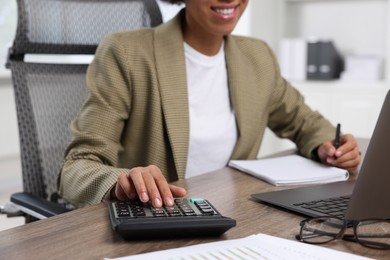 Professional accountant working at wooden desk in office, closeup