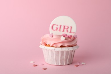 Photo of Baby shower cupcake with Girl topper on pink background