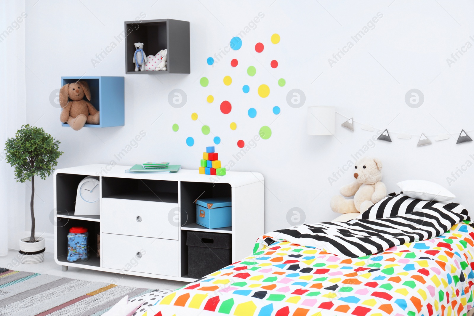 Photo of Modern child room interior with comfortable bed and striped carpet