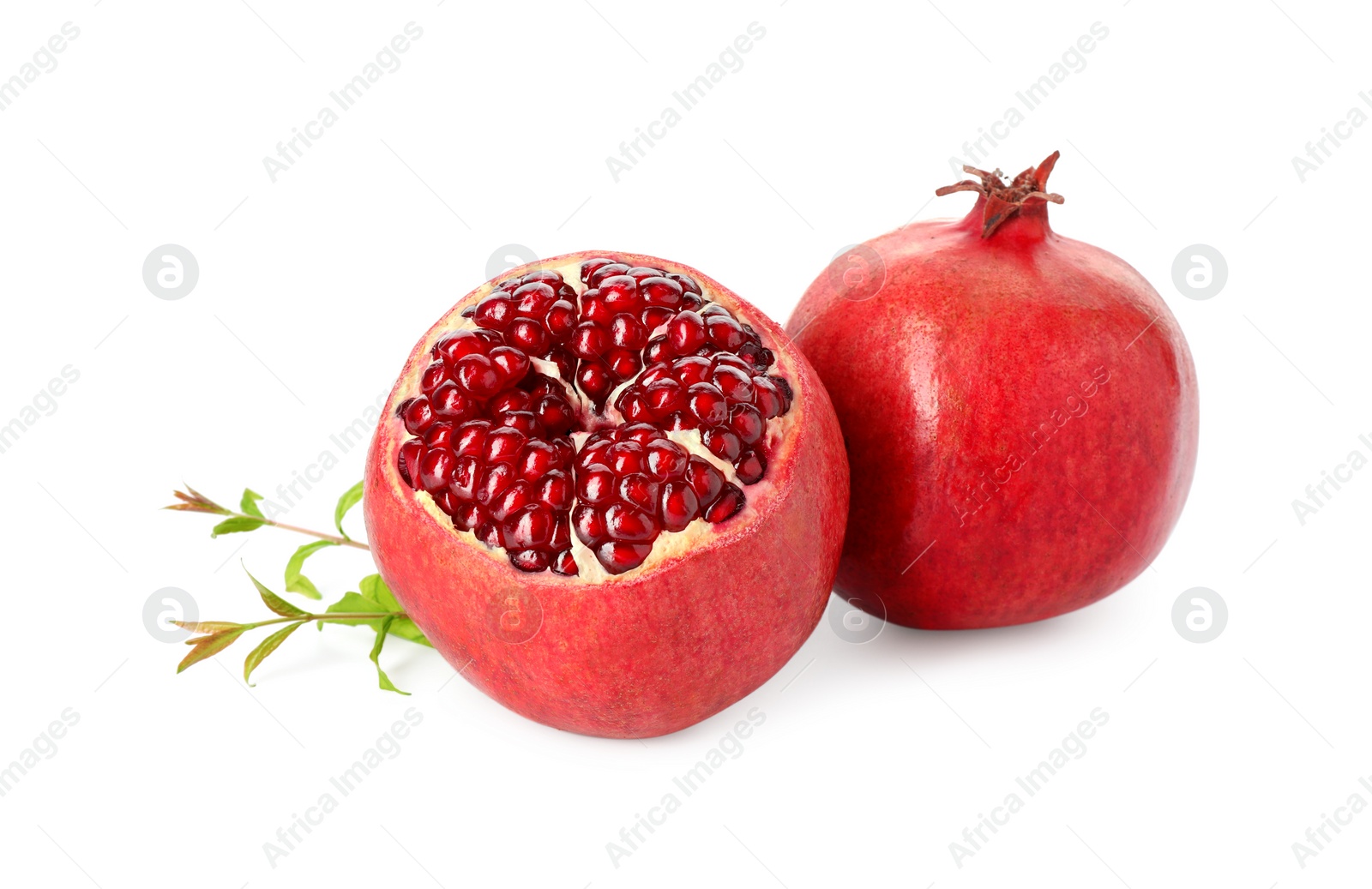 Photo of Fresh ripe pomegranates and green leaves isolated on white