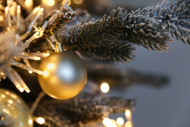 Closeup view of beautiful decorated Christmas tree on light background