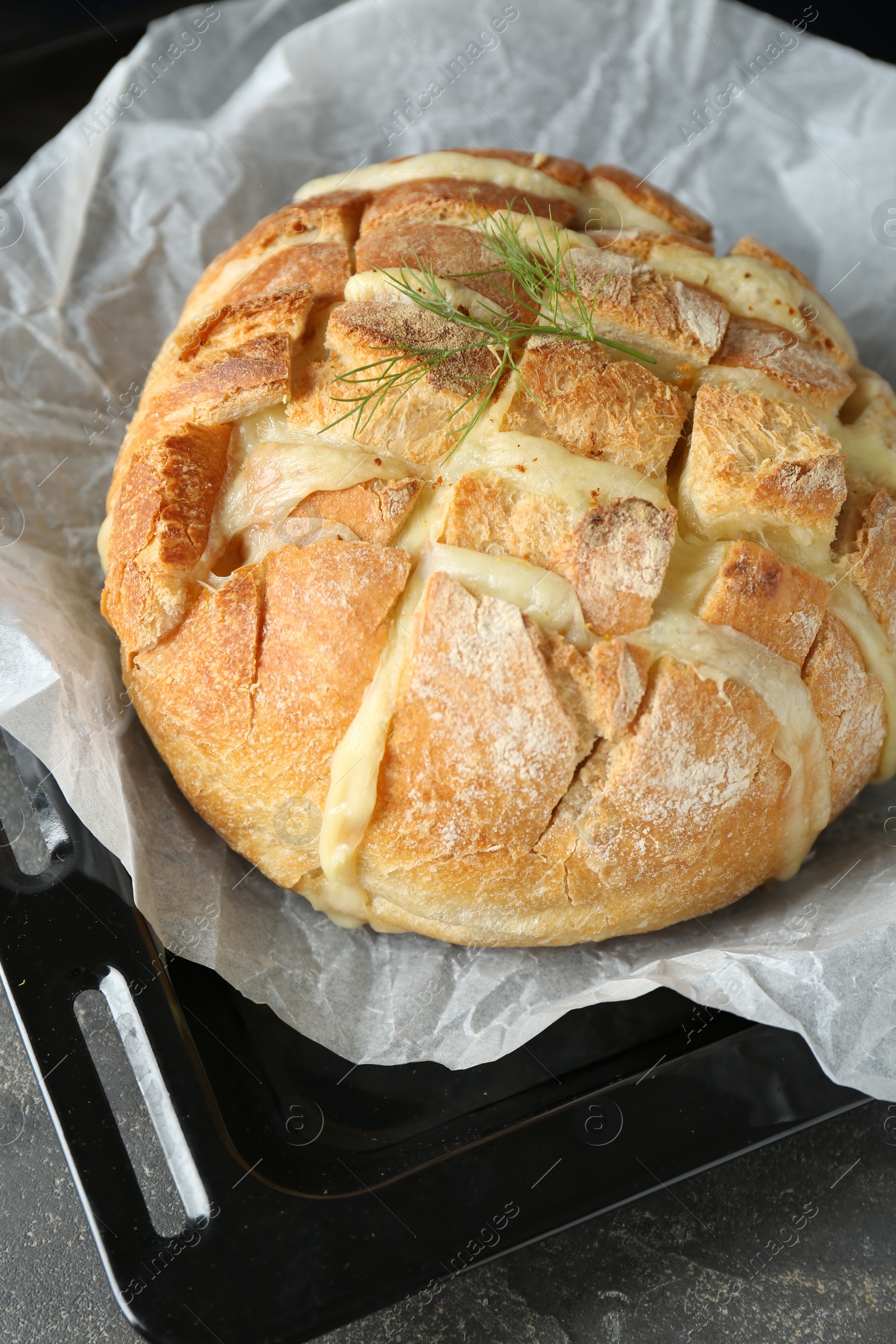 Photo of Freshly baked bread with tofu cheese on table