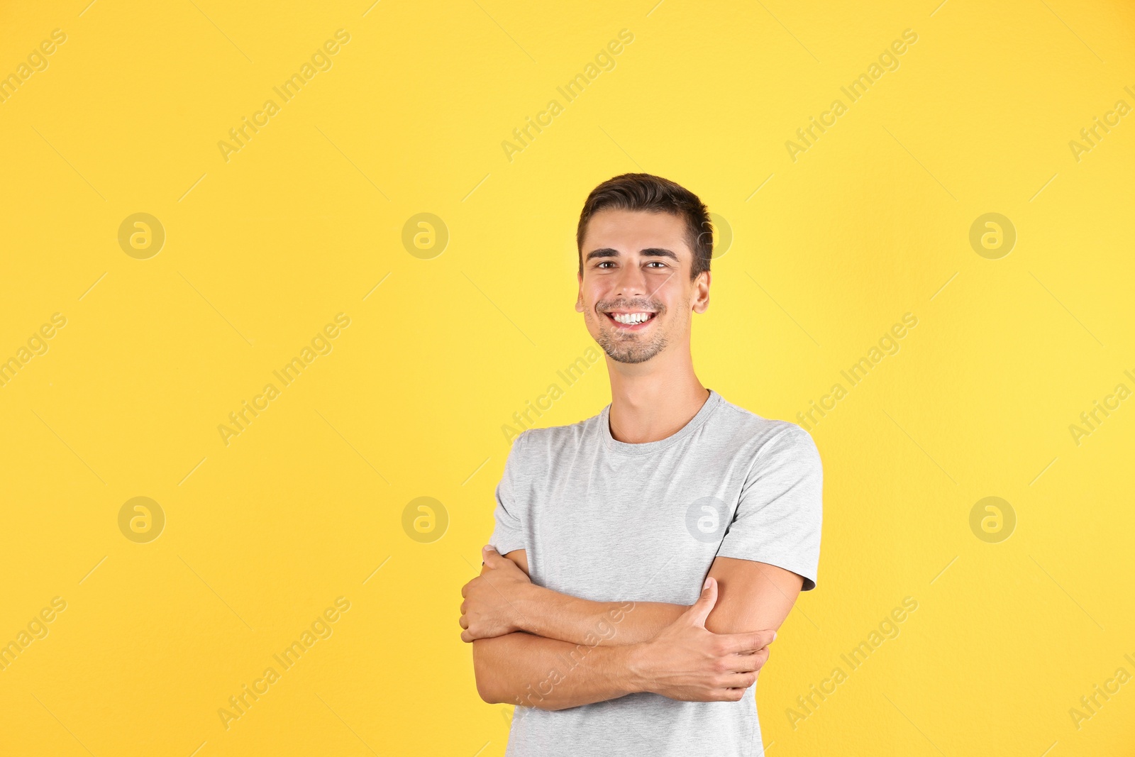 Photo of Portrait of handsome young man smiling on color background. Space for text