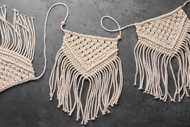 Photo of Stylish beige macrame on grey table, top view