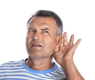 Mature man with hearing problem on white background