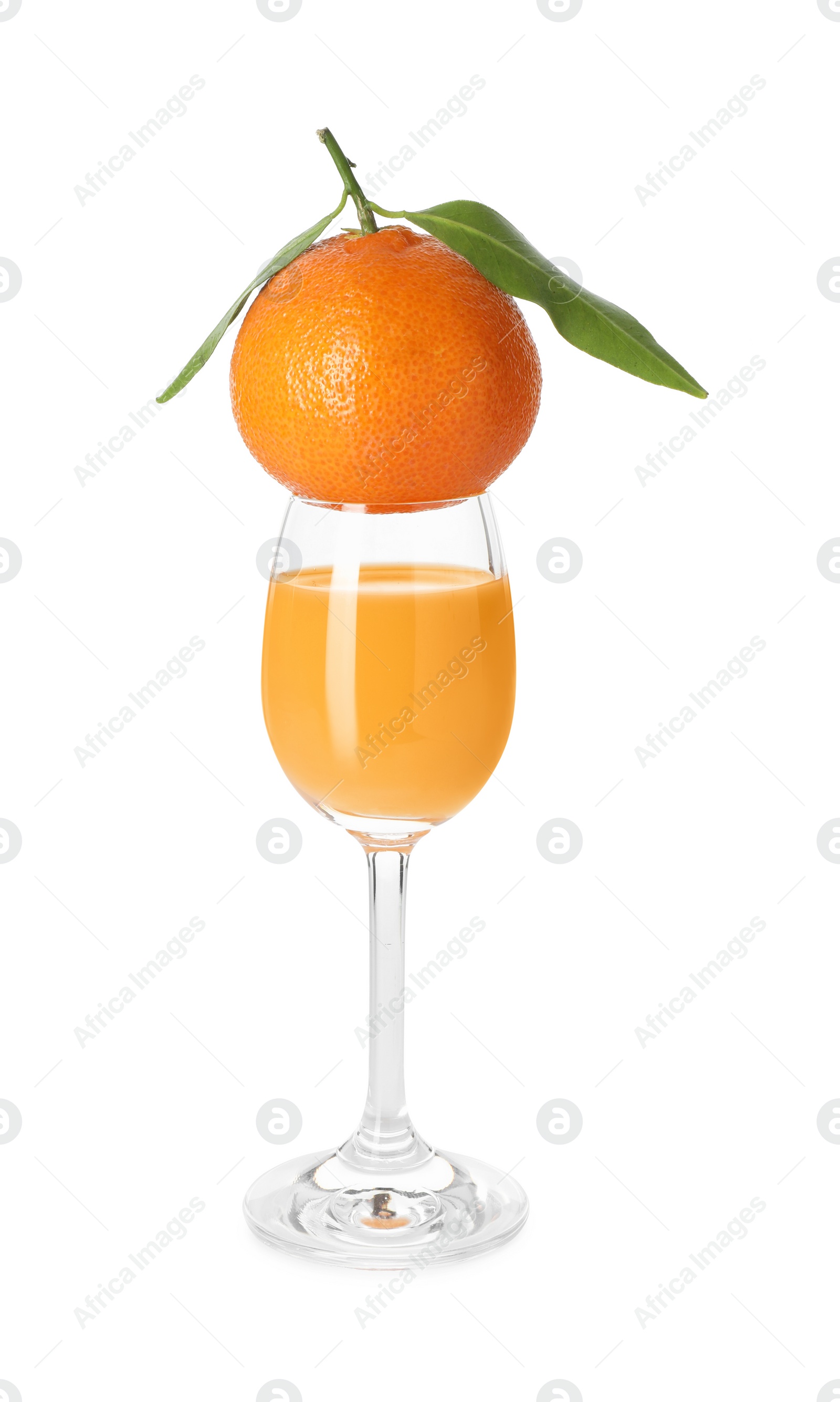 Photo of Tasty tangerine liqueur in glass and fresh fruit isolated on white