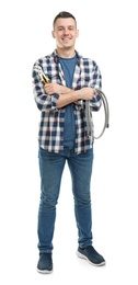 Young plumber with hose and adjustable wrench on white background