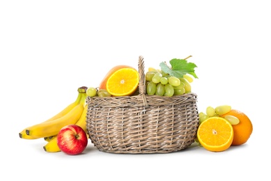 Photo of Wicker basket with different fruits on white background