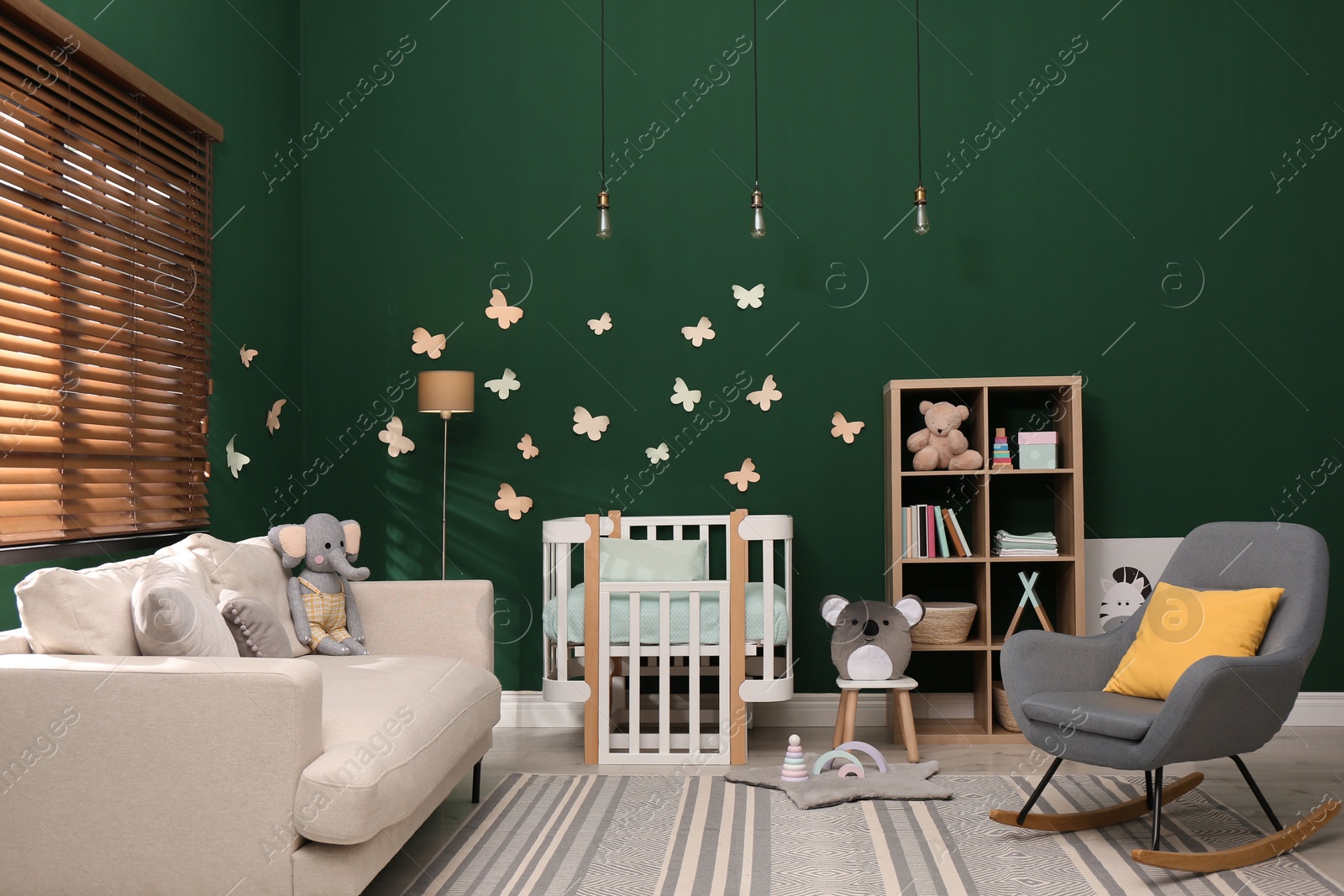 Photo of Beautiful baby room interior with stylish furniture and comfortable crib