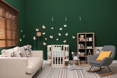 Beautiful baby room interior with stylish furniture and comfortable crib