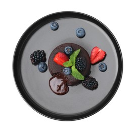 Plate with delicious chocolate fondant, berries and mint isolated on white, top view