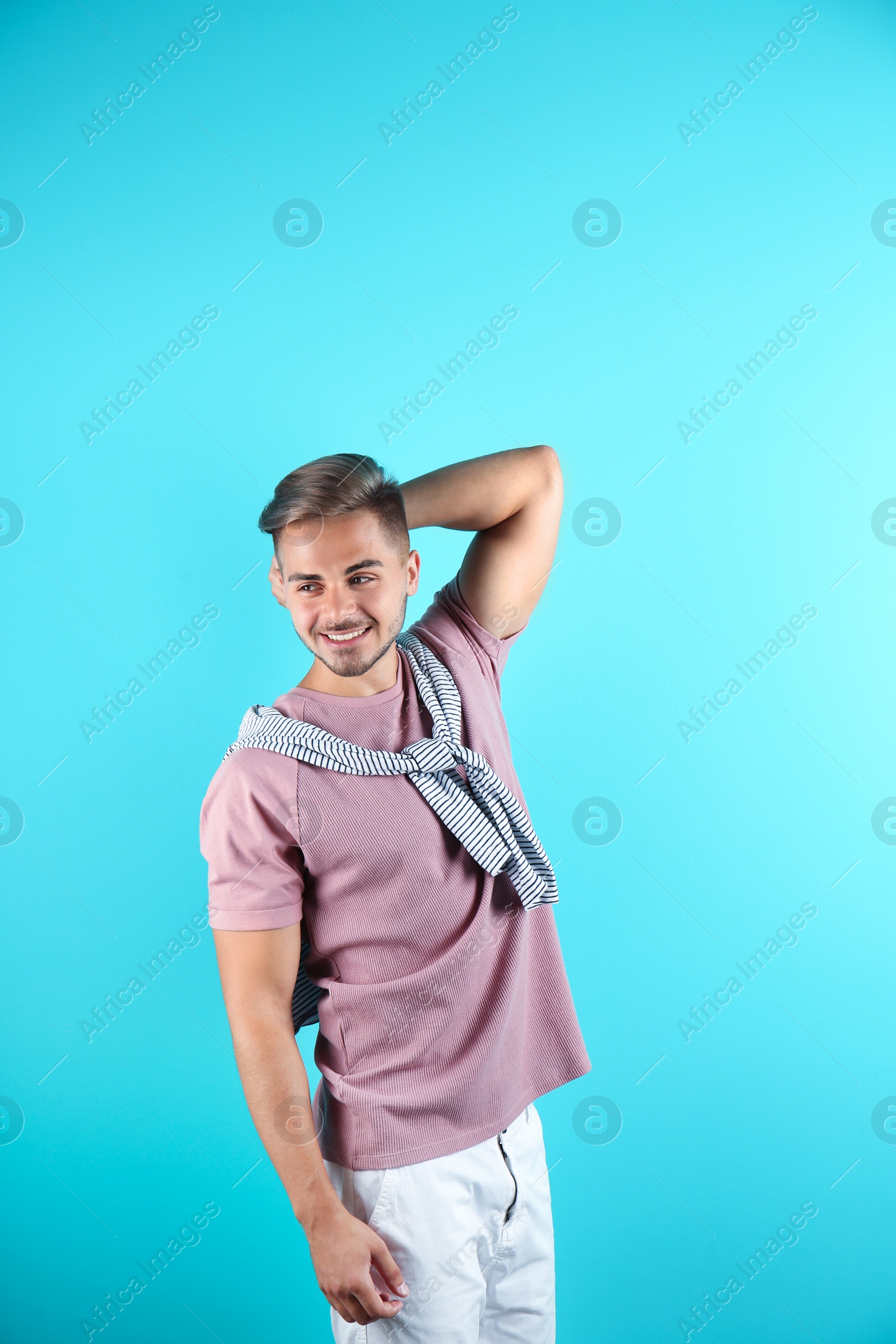 Photo of Young man with trendy hairstyle on color background