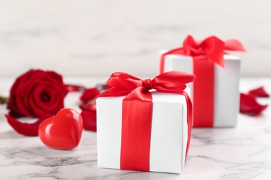 Photo of Beautiful gift boxes on marble table, closeup. Valentine's Day celebration