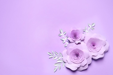 Photo of Beautiful flowers and branches made of paper on violet background, flat lay. Space for text