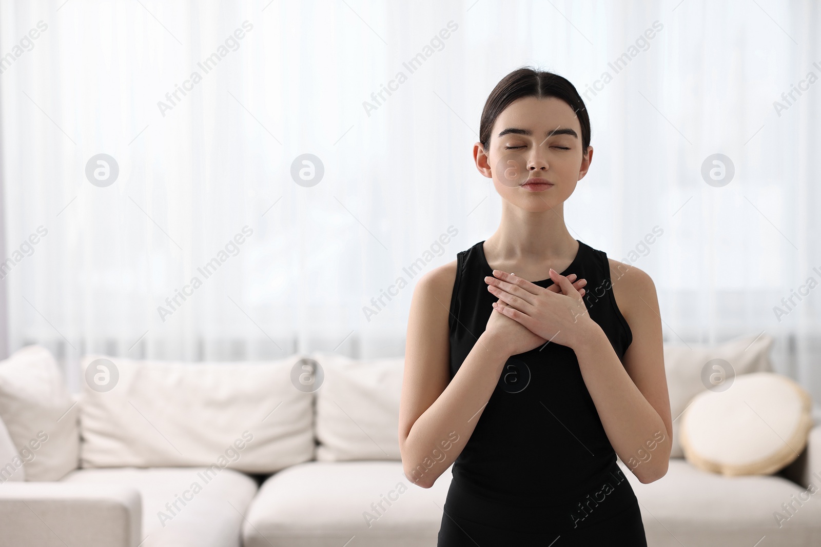 Photo of Beautiful girl meditating at home. Practicing yoga