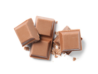 Photo of Pieces of delicious milk chocolate isolated on white, top view