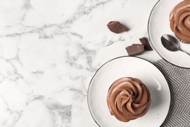 Photo of Delicious fresh chocolate cupcakes on white marble table, flat lay. Space for text
