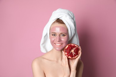 Photo of Young woman with pomegranate face mask and fresh fruit on pink background