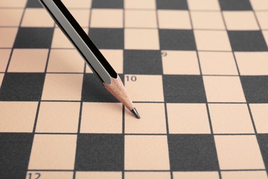 Pencil and blank crossword, closeup. Space for text