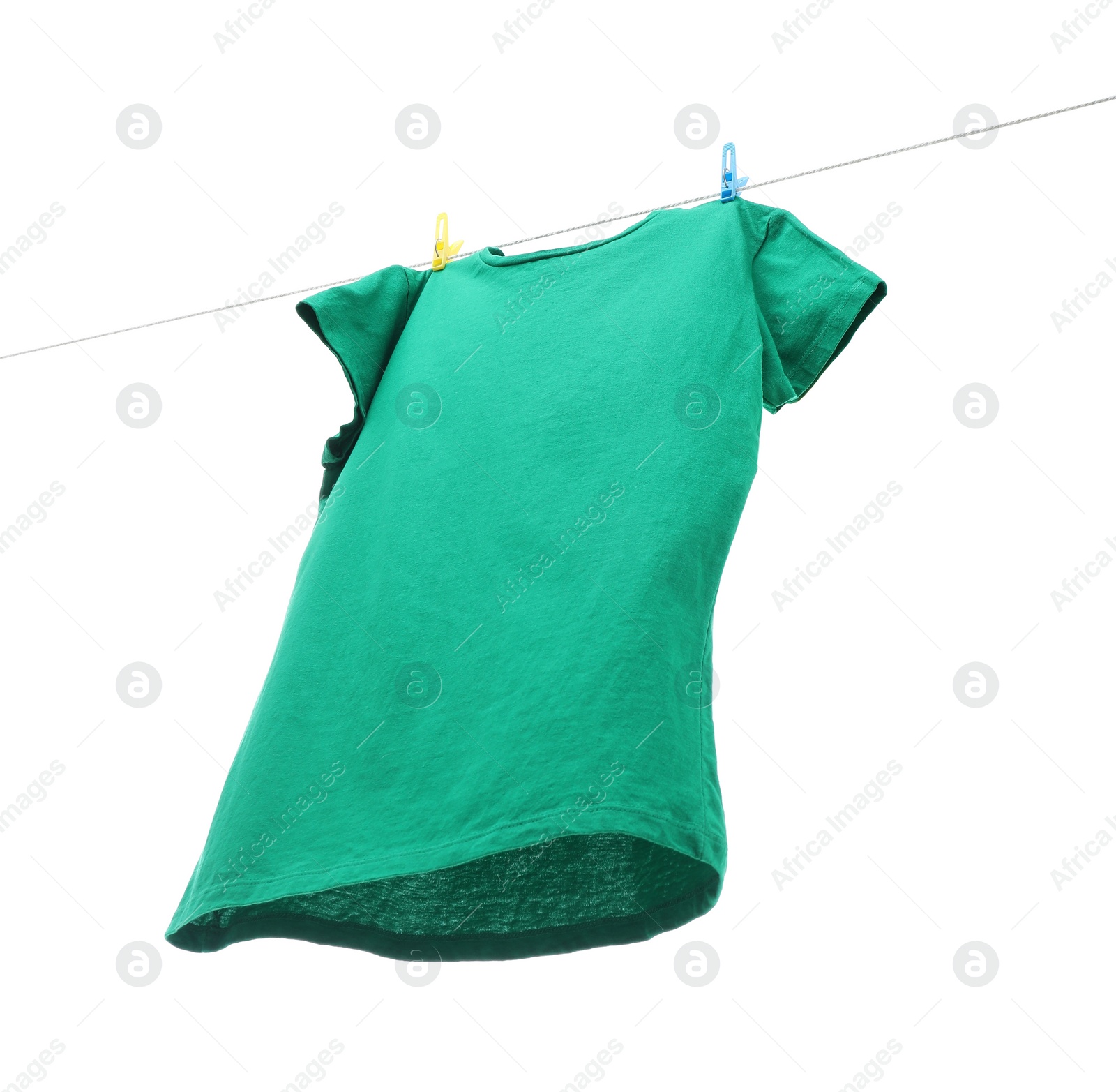 Photo of One green t-shirt drying on washing line isolated on white