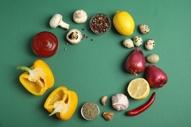 Photo of Frame of ingredients for cooking on green background, flat lay. Space for text