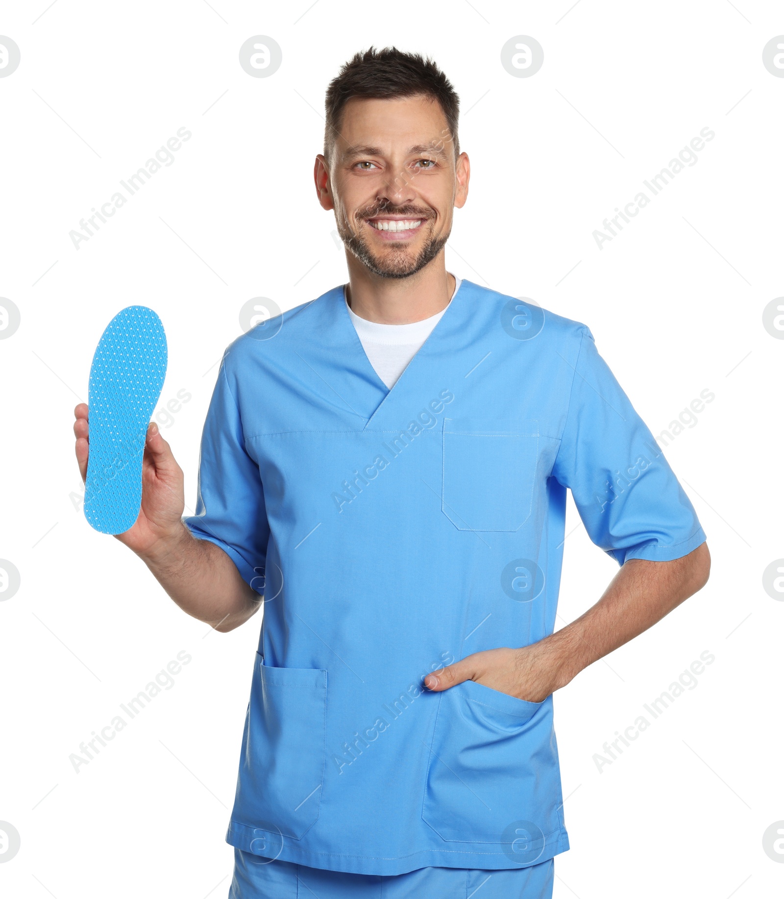 Photo of Handsome male orthopedist showing insole on white background