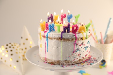 Photo of Tasty Birthday cake with burning candles on table, closeup