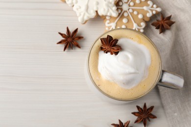 Photo of Cup of delicious eggnog with anise star on wooden table, flat lay. Space for text