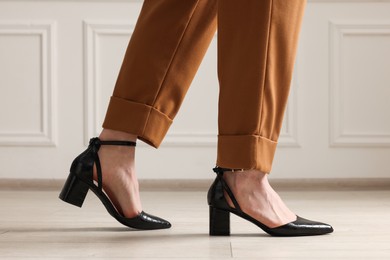 Photo of Businesswoman in elegant leather shoes indoors, closeup