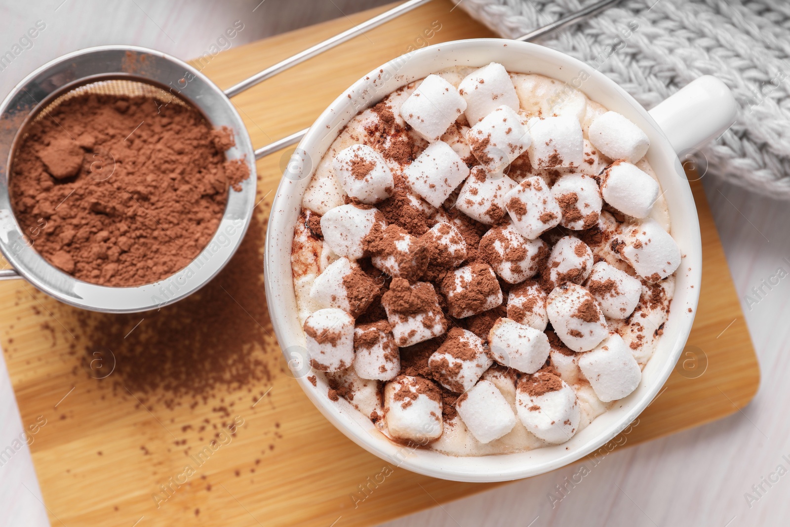 Photo of Cup of aromatic hot chocolate with marshmallows and cocoa powder on table, top view