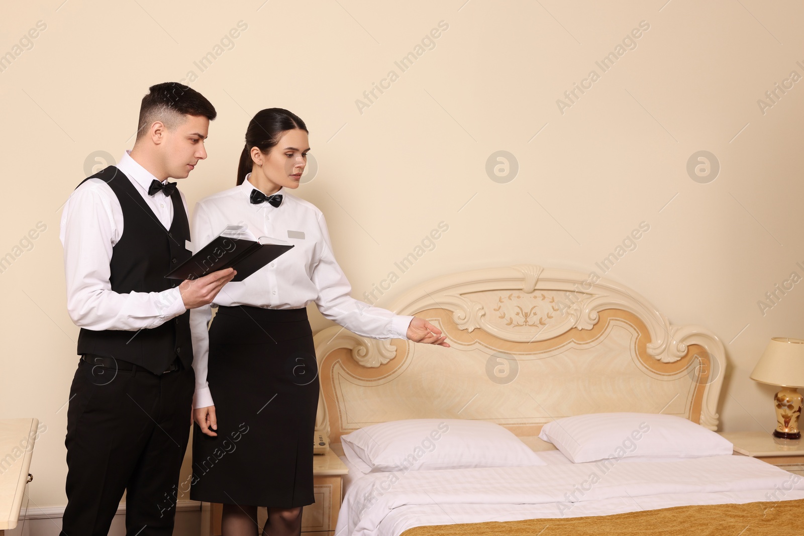 Photo of Young people attending professional butler courses in hotel. Space for text