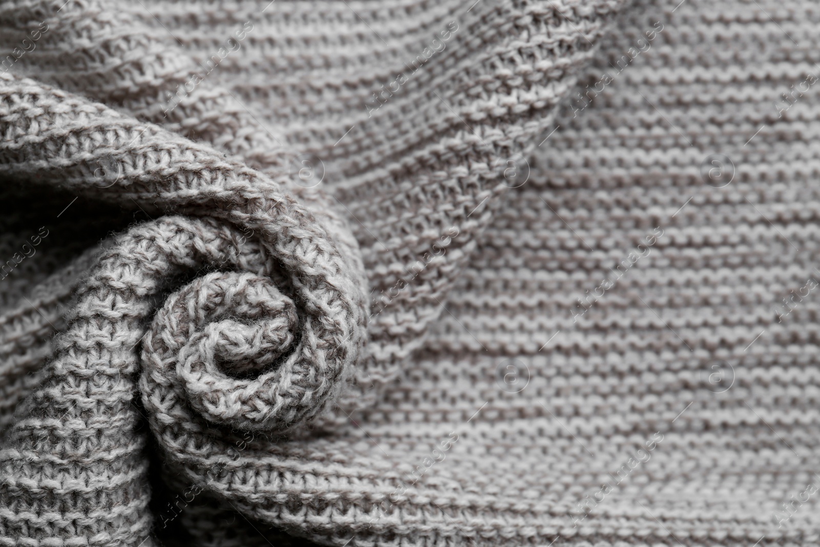 Photo of Beautiful grey knitted fabric as background, top view