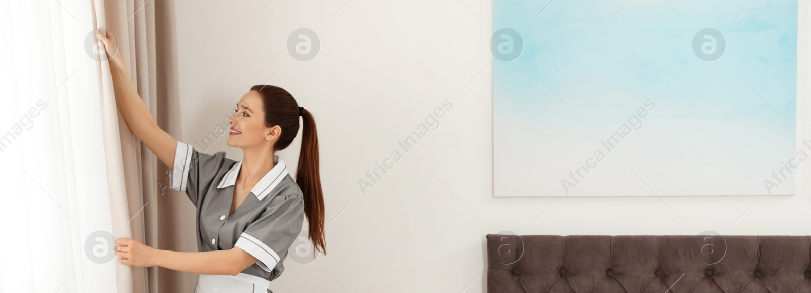 Image of Chambermaid adjusting curtains in hotel room, space for text. Banner design