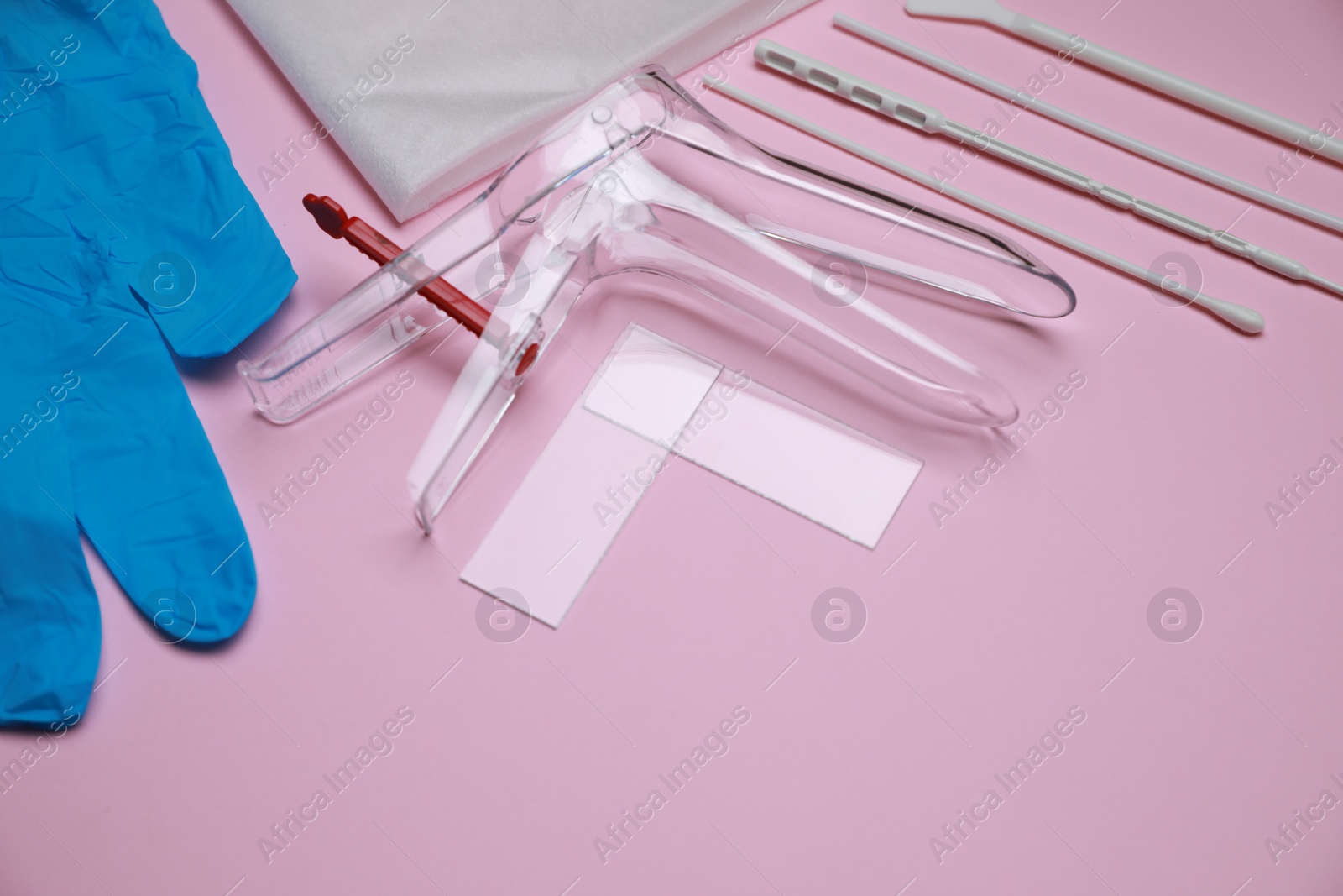 Photo of Sterile gynecological examination kit on pink background. Space for text