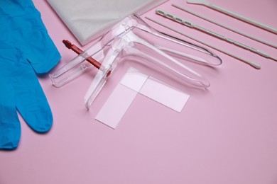 Sterile gynecological examination kit on pink background. Space for text