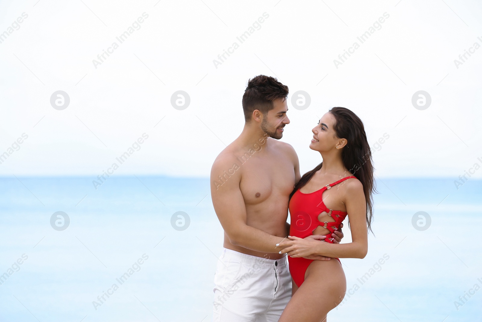 Photo of Happy young couple spending time together on beach