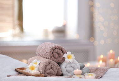 Photo of Beautiful spa composition on massage table in wellness center