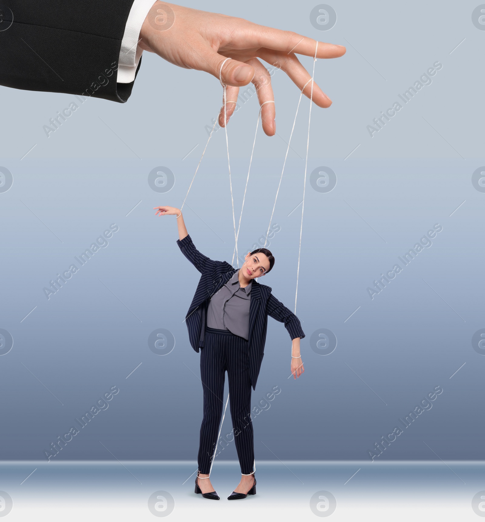 Image of Human relationships demonstrated in puppet show. Worker manipulated by director or manager on light blue background