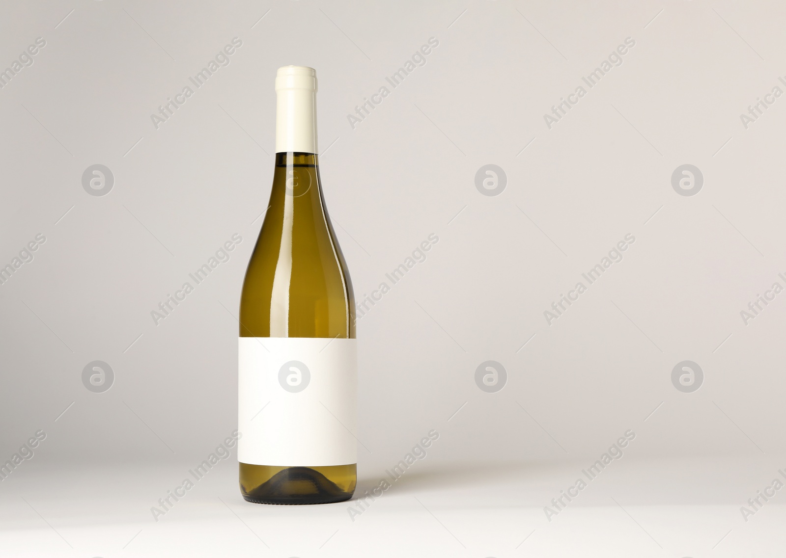 Photo of Bottle of tasty wine on white background, space for text