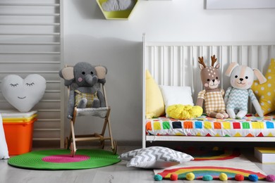Photo of Baby room interior with stylish furniture and toys