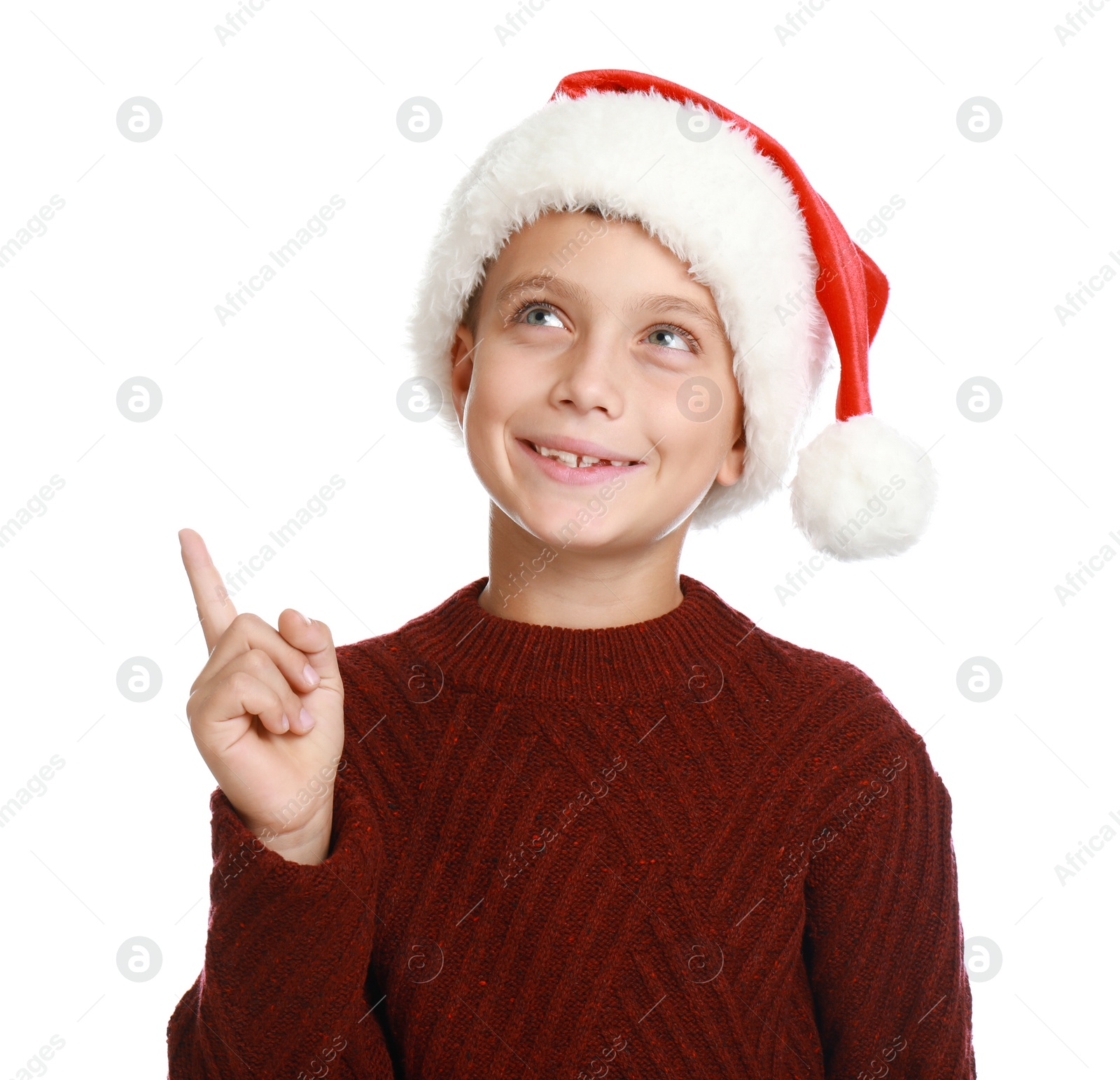 Photo of Happy little child in Santa hat on white background. Christmas celebration