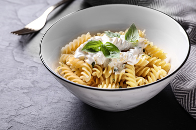 Delicious pasta with sauce served on black table, closeup