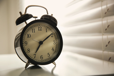 Alarm clock on windowsill, space for text. Morning time