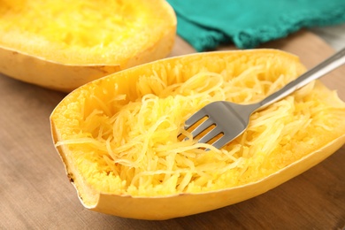 Cooked spaghetti squash and fork on table