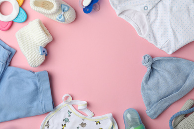 Photo of Flat lay composition with child's clothes and accessories on pink background, space for text