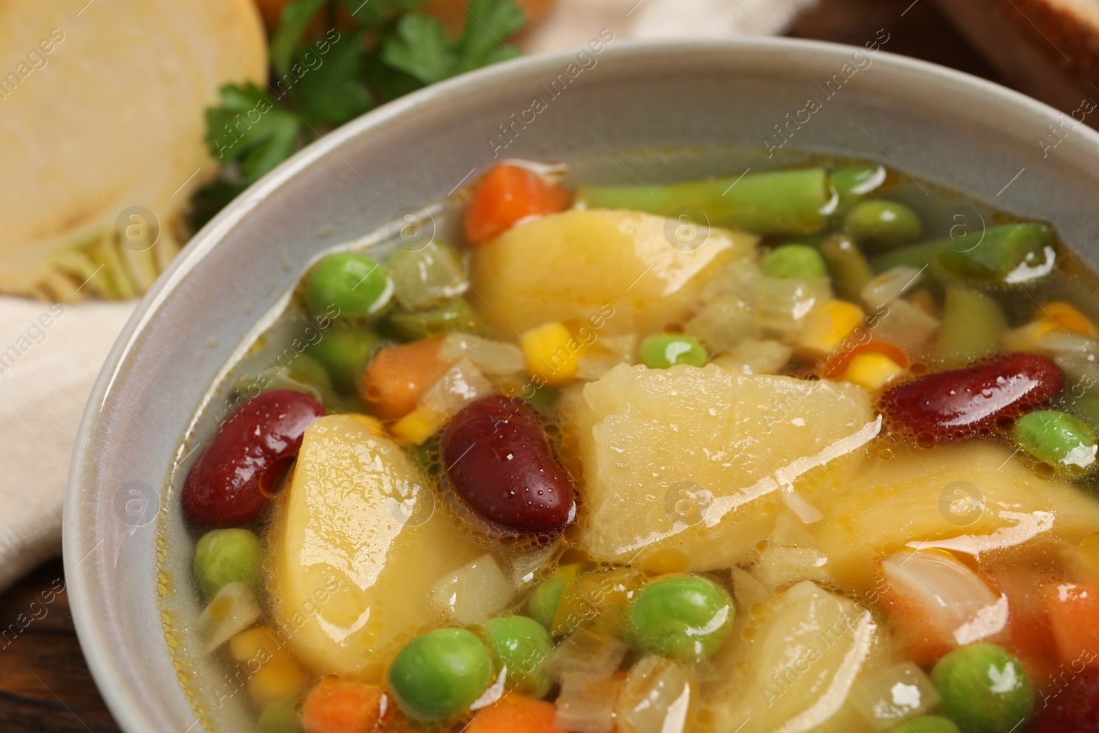 Photo of Bowl of delicious turnip soup on table, closeup view