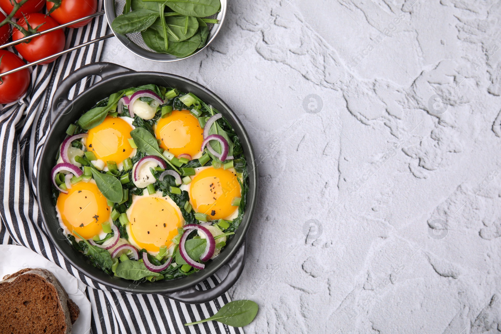 Photo of Flat lay composition with tasty Shakshouka and ingredients on white textured table. Space for text